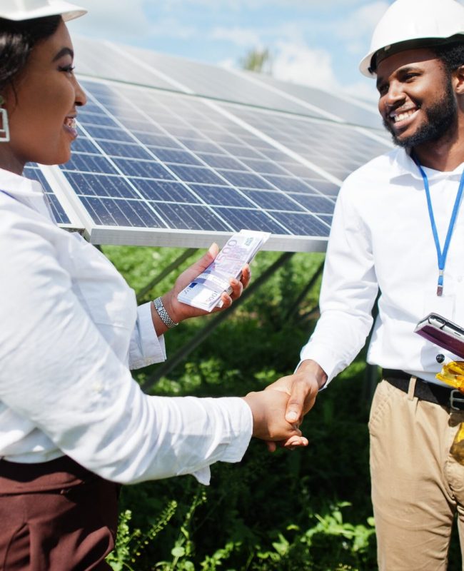 african-american-technician-checks-maintenance-solar-panels-group-three-black-engineers-meeting-solar-station-make-deal-with-money-scaled.jpg
